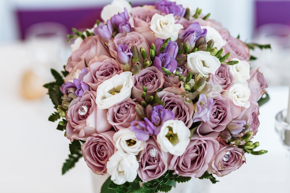 A close-up of a floral bouquet arrangement delivered by Flowers Belgravia, featuring soft pink roses, white lisianthus, and purple freesias, all freshly bloomed with delicate, textured petals and gree